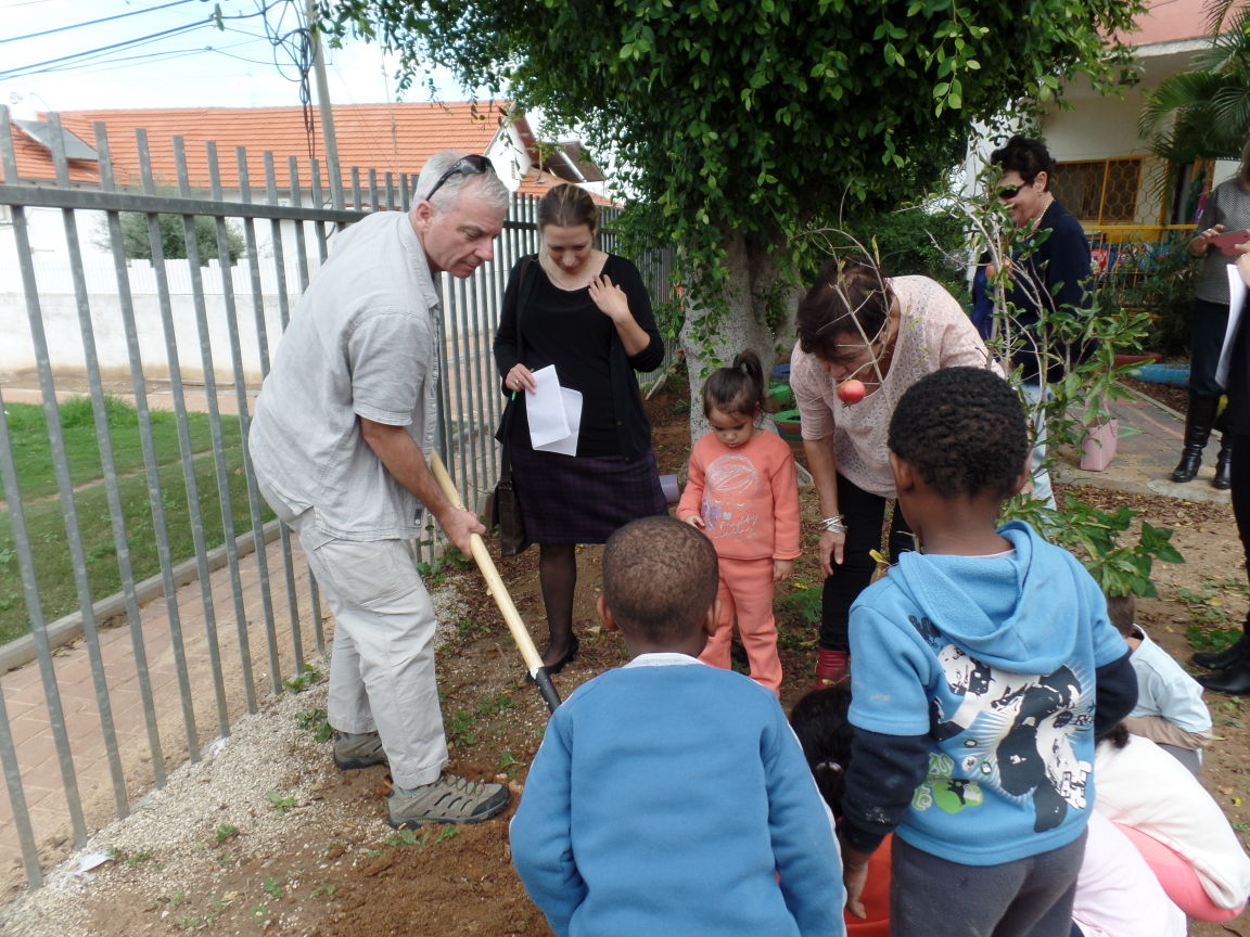 Jim Hartnett, director of community-wide security for the Jewish Federation of Cleveland, helps to plant a tree at a school in Beit Shean, Cleveland’s sister city in Israel.