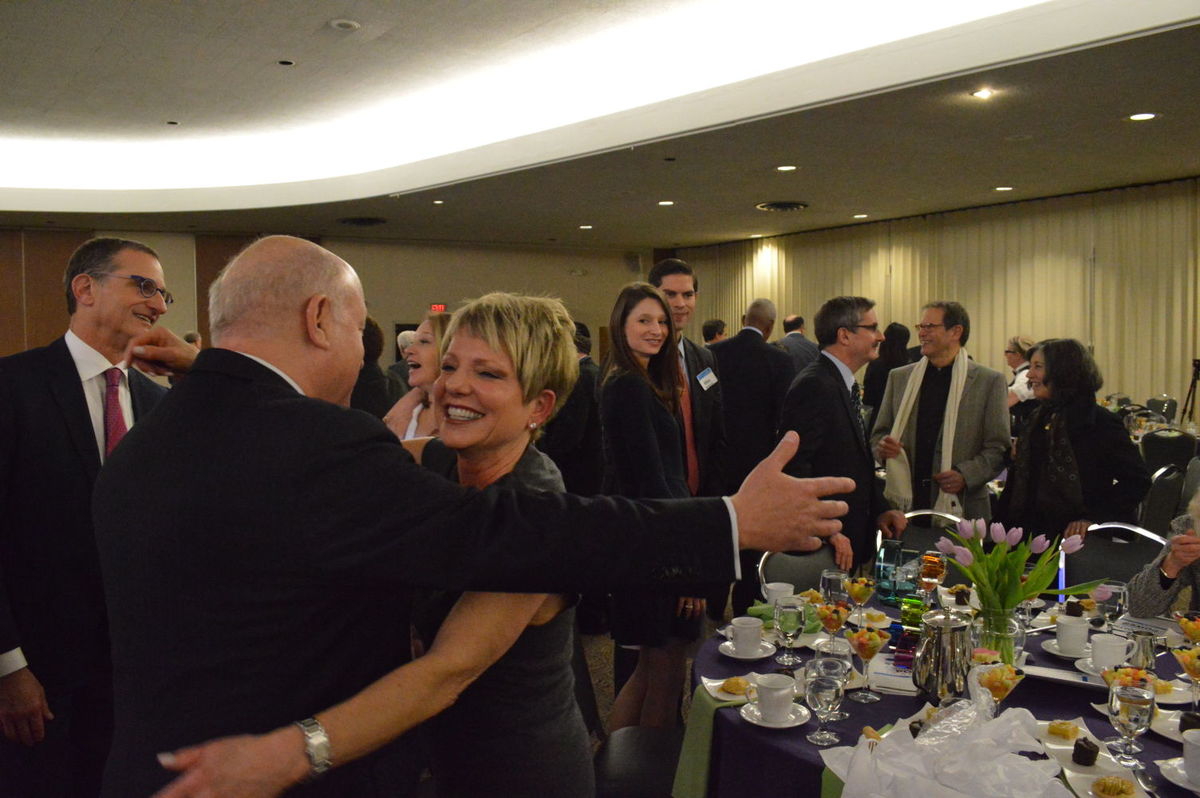 Stephen H. Hoffman, president of the Jewish Federation of Cleveland, gives Renee Chelm a hug after she was recognized for her three years as Federation board chair.